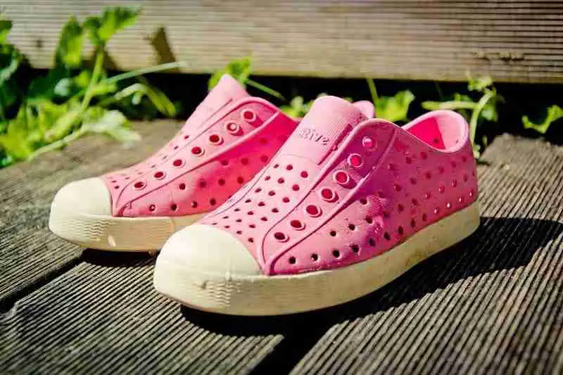 a pair of van-like looking pink crocs